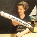 Artist Jenny Lockyer holding a rocket
